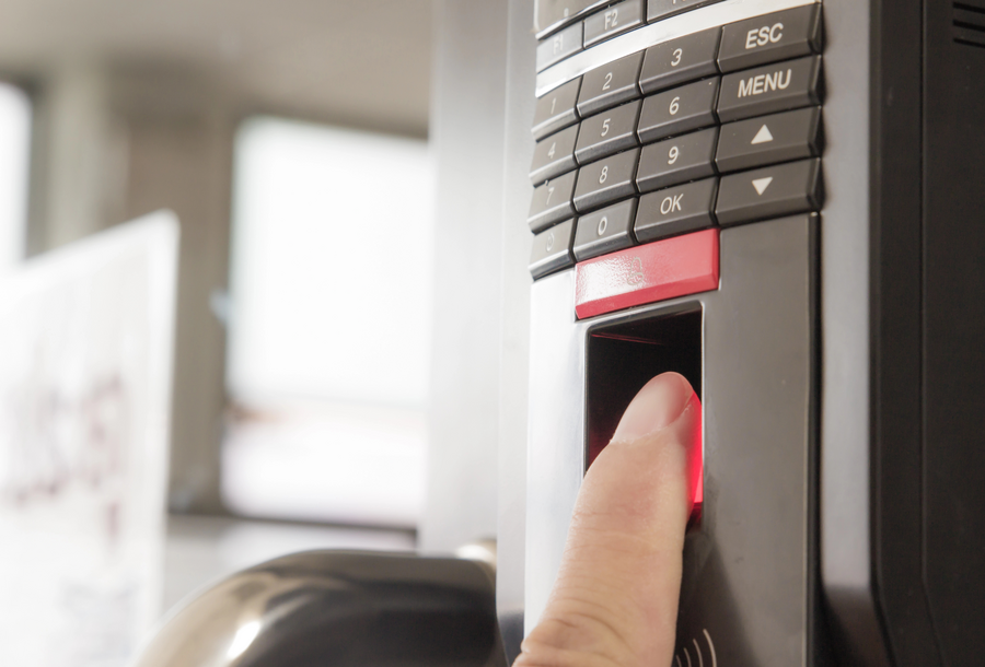 Individual touching a door button, engaging with a home security system.