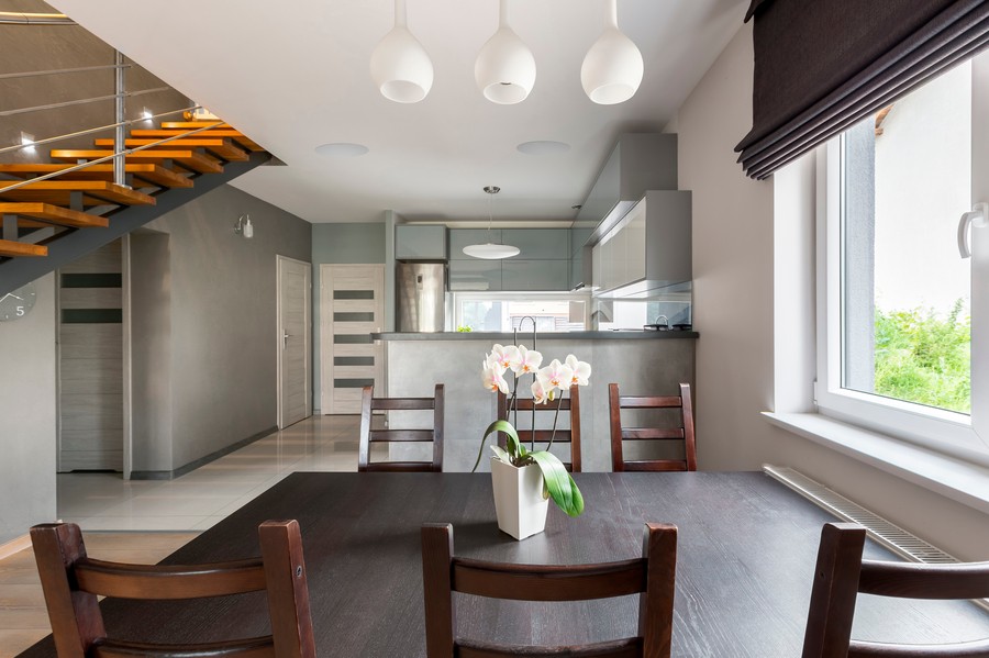 A modern kitchen area with two ceiling speakers above the food preparation area.