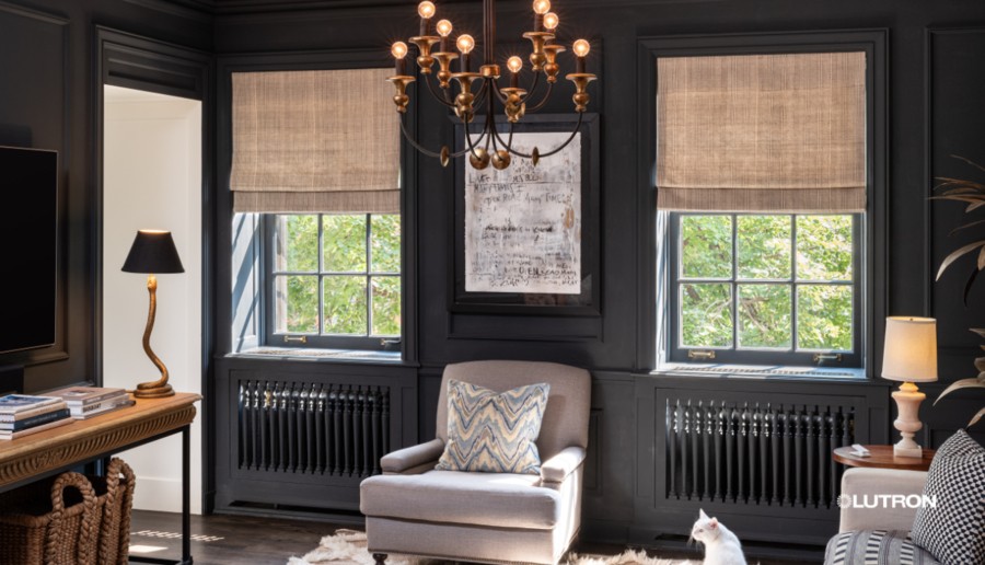 A fashionable home office with black wall paint and Lutron motorized shades on windows. 