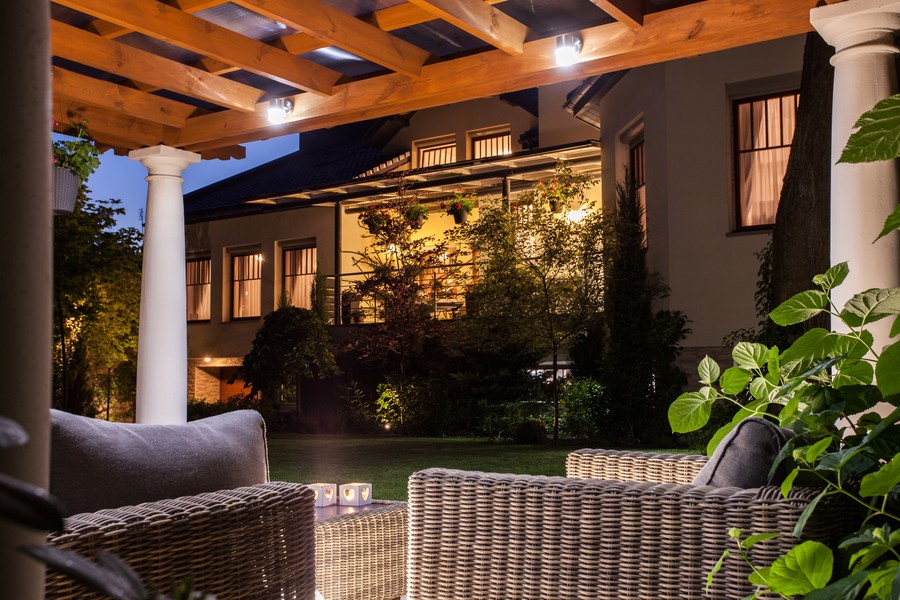 an outdoor seating area overlooking a home with automated lighting control