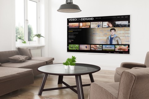 living room seating area facing a large screen TV mounted to the wall for high-performance home entertainment