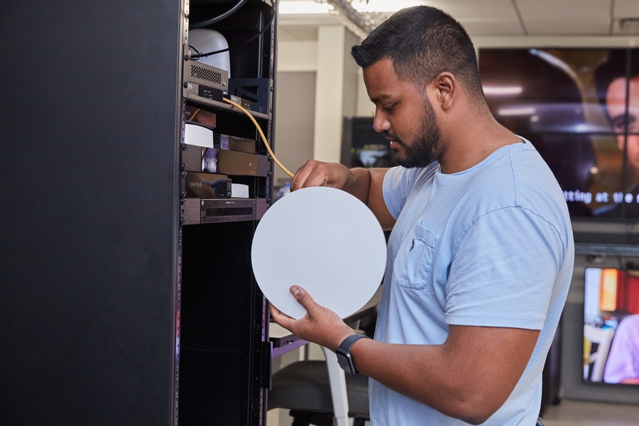 A professional installer putting the finishing touches on a home network.