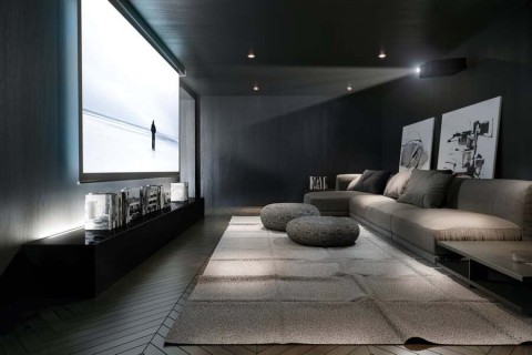 A luxurious and cozy home theater with a snowy landscape displaying on screen.